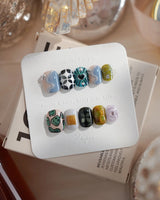 Mindbend extra short squoval nails with abstract retro art and 3D chrome texture