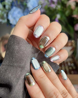 Mirrorplay sci-fi nails with reflective color blocks and shifting mirrored cat-eye effects