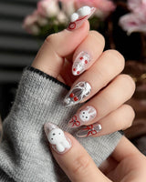 Close-up of Miss Miffy press-on nails with 3D rabbit, cherries and silver metallic details