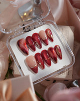 Molten Rouge medium stiletto press-on nails with deep red cat-eye and gold crystal accents