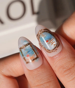 Monet Sunrise L press-on nails in short almond with blue water and a red sun