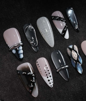 Monochrome press on nails mixing black and white marble, liquid chrome, polka dots, silver beads and a chrome bar across ten nails - image 1