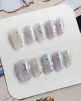 Moonrest serene night nails with moon charm, star glitter, and glossy gel finish