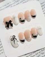 New Year Glam press-on nails in extra short oval shape — Classic Black & White, 3D Bows & French Outlines.
