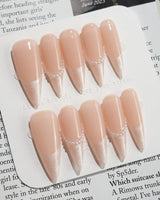 Dew Sparkle in long stiletto shape with nude French tips, pearl accents, and silk shine