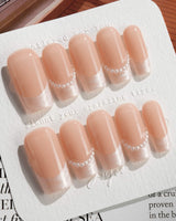 Dew Sparkle in medium square shape with pearly French tips and polished nude gel
