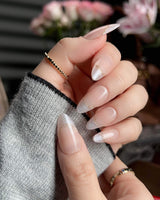 Your Glow nude French tip nails with soft cat-eye shimmer and delicate gold wire accents