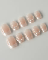 Dew Sparkle in extra short squoval shape with pearly French tips and soft nude color