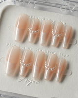 Dew Sparkle in medium coffin shape with pearly French tips and soft nude base