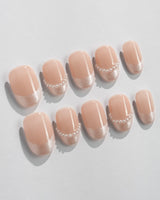 Dew Sparkle in short oval shape with pearly nude French design and glossy gel finish