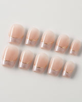 Your Glow in extra short coffin shape with nude French tips and subtle gold accents