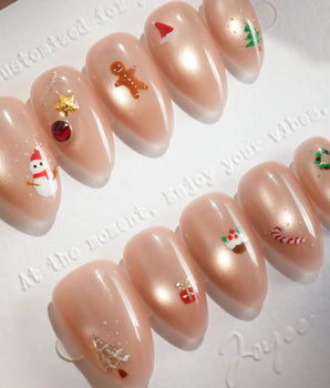Mini Noel handmade press-on nails featuring nude cat eye christmas icons