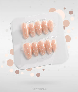 Cloud Cream handmade press-on nails featuring Peach Nude, Sweet White Polka Dots.