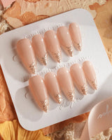 Nude Spark press-on nails in medium stiletto shape — Premium Champagne Cat Eye, Irregular French Metal Outlines.
