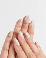 Oat Latte press-on nails in extra short almond shape — Sheer Nude Skin, Minimalist Silver Glitter Swirls.