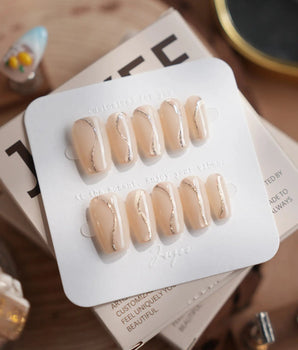Oat Latte press-on nails in short coffin shape — Sheer Nude Skin, Minimalist Silver Glitter Swirls.