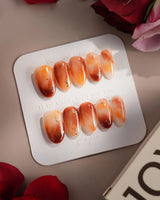 Onyx Shine nail set with warm amber marble design and hand-painted glossy gel depth