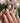 Handmade orchid nail art with pastel petals and shine