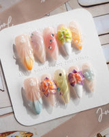 Orchid-Extra Glow press-on nails in medium stiletto shape — Colorful Summer, 3D Orchids & Shell Textures.