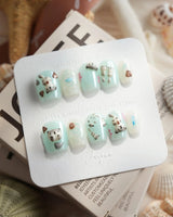 Otter Momo extra short coffin nails with 3D otter and mint cream jelly base