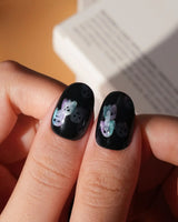 Party Spirits press on nails with holographic teal, lilac and pink glitter ghosts on a glossy black base - image 5