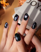 Party Spirits press on nails with holographic teal, lilac and pink glitter ghosts on a glossy black base - image 3