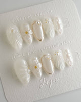 Pearl Bloom press-on nails in extra short almond shape — Pure White Pearlescent, 3D Flowers & Shell Texture.