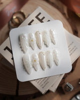 Pearl Bloom press-on nails in medium stiletto shape — Pure White Pearlescent, 3D Flowers & Shell Texture.