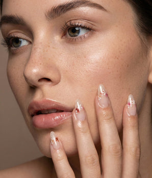 Petal Press handmade press-on nails featuring Warm Creamy Skin Tone, Hand-painted Florals & glitter Shimmer.