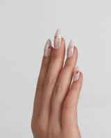 Petal Press press-on nails in extra short almond shape — Warm Creamy Skin Tone, Hand-painted Florals & glitter Shimmer.