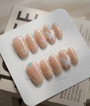 Petal Rain press-on nails — nude, 3D White Butterfly Wings & Pastel Wildflowers. handmade nail art by Joyee Nails