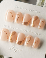 Poetic Glamour Nude press-on nails in extra short coffin shape — nude french tip gold line