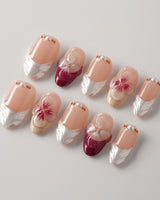 Duchess Purple shimmer nails with 3D floral details and soft magenta French styling