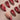Molten Rouge press-on nails with deep red cat-eye, nude base, gold outlines and crystal accents
