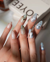 Renaissance Fresco S press-on nails in short almond with sky blue clouds and stars