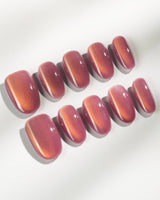 Rose Brew press-on nails in medium oval shape — Maroon cat eye nails