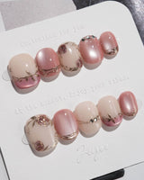 Rose-Théâtre Noir press-on nails in extra short squoval shape — Elegant Rose Pink, Embossed Florals & Metallic Edging.