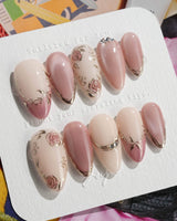 Rose-Théâtre Noir press-on nails in medium almond shape — Elegant Rose Pink, Embossed Florals & Metallic Edging.