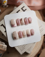 Rose-Théâtre Noir press-on nails in short square shape — Elegant Rose Pink, Embossed Florals & Metallic Edging.