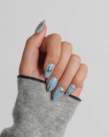 Sea Chrome extra short almond nails with rose gold, silver, and oil-slick ocean details