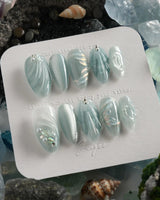 Dead Sea Blue handmade almond nails with pearl shell texture and glassy seafoam finish