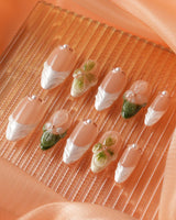 Close-up of Duchess Olive nails with olive green French tips and dimensional floral details