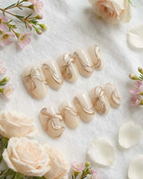 Silk Bow press-on nails in short oval shape — Luxury Creamy White & Gold, 3D Champagne Gold Wire Bows & Fine Shimmer.