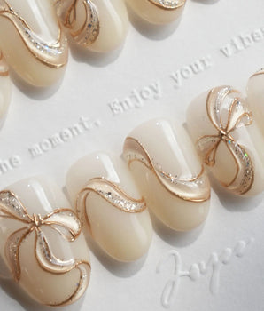 Silk Bow handmade press-on nails featuring Luxury Creamy White & Gold, 3D Champagne Gold Wire Bows & Fine Shimmer.