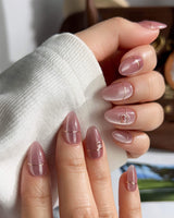 Simple love nail art close-up showing Gentle Blush Cat Eye, Simple Gold Lines & 3D Hearts. details