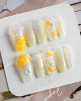 Slushie Lemon press-on nails with pale icy blue, white glitter, and juicy lemon details