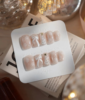 Snowfall press-on nails in extra short square shape — pearl nude cat eye snowflake bow silver glitter soft sheen