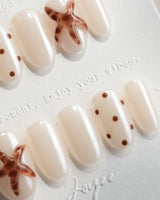 Starfish & Dots close-up of tortoiseshell starfish and brown polka dot nail art