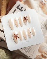 Starfish & Dots medium almond nails with tortoiseshell starfish and ivory dot pattern