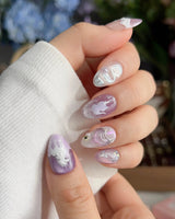 Stargaze extra short almond nails with pastel star details and sculpted dreamlike accents
